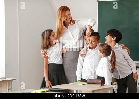Children with teacher in classroom Stock Photo