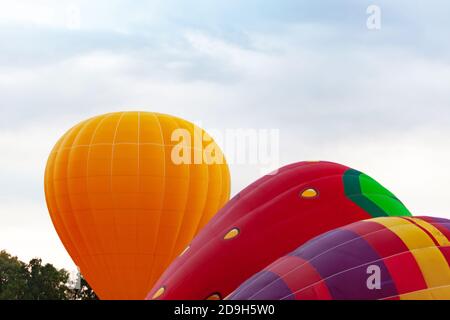 three balloons against cloudy skies Stock Photo