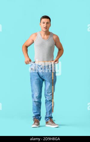 Man with sudden weight loss problem on color background. Diabetes symptoms Stock Photo