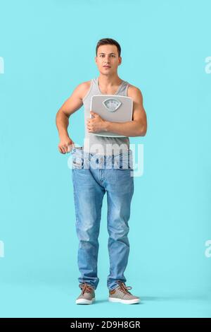 Man with sudden weight loss problem on color background. Diabetes symptoms Stock Photo