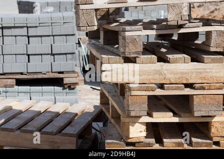empty wooden pallets and new construction tiles Stock Photo