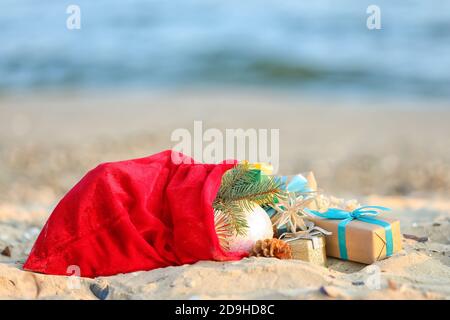 Santa Claus with sack on beach near sea. Christmas vacation Stock Photo ...