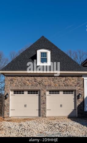 Three car garage exterior with stone veneer and green board and batten ...