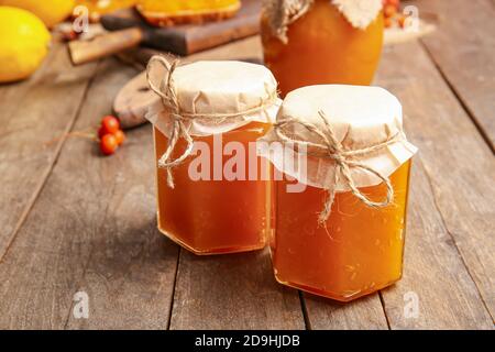 Jars of tasty pumpkin jam on table Stock Photo