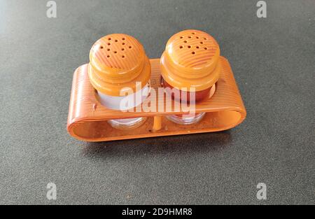 Salt and pepper stand on a table. Salt shaker and pepper shaker with stand in a cafe on the table. Stock Photo