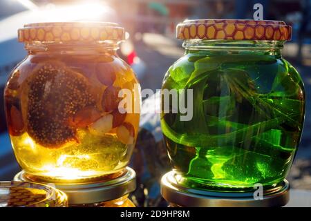 Nuts with honey in glass jars. Harvest of nuts. Delicacy and