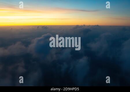 Aerial view from the plane of colorful sky, clouds before sunrise. Soft selective focus Stock Photo