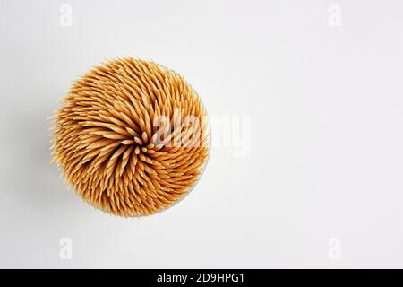 top view of bamboo toothpicks in a plastic storage box on white background, copy space. Stock Photo