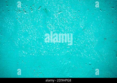blue painted cement wall with dots and cracks, texture background Stock Photo