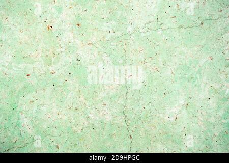 old painted cracked background, textured wall of green and beige colors Stock Photo