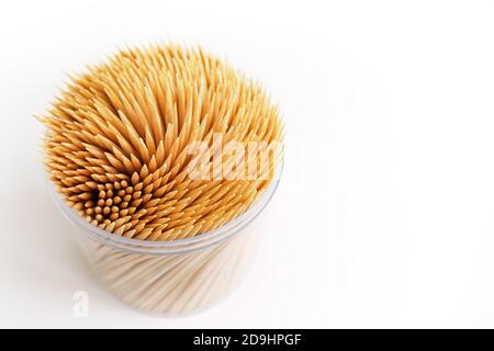 bamboo toothpicks in a plastic storage box on white background, copy space, selective focus Stock Photo