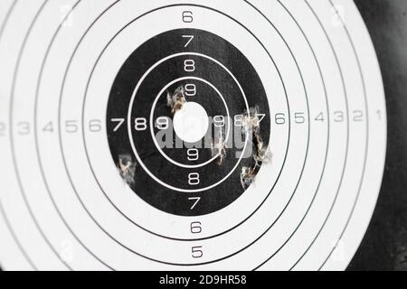 closeup of papaer shooting target with bullet holes Stock Photo