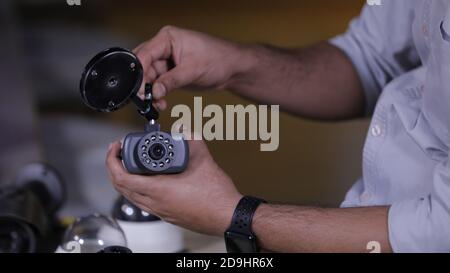 A man repairing security camera in service center Stock Photo