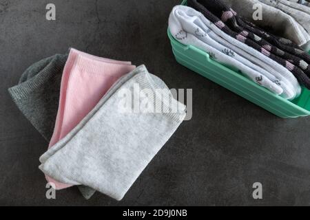 Three pairs of children's socks on dark background Stock Photo