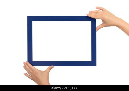 female hands holding mockup frames isolated on white background. Certificate, diploma, picture, gratitude white frame mockup. blue color frame Stock Photo