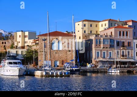 Sailing boats anchored by piers of Old Venetian harbour and Grand Arsenal, Venetian shipyard, in Chania, Crete, Greece. Stock Photo