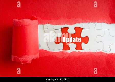 UPDATE text on jigsaw puzzle and torn paper. Selective focus Stock Photo