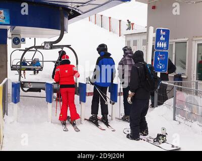 SINAIA, ROMANIA - DECEMBER 11, 2015. Skiers and Snowboarders waiting to get on the ski lift in Sinaia, the most famous mountain resort in Romania Stock Photo