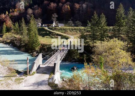 Mother and son walking a on suspension bridge over Soca river, Soca River Valley, Slovenia Stock Photo