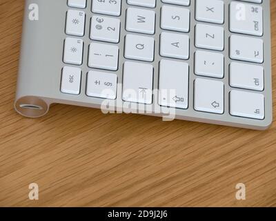 Closeup of battery compartment with screw cap cover with coin slot on Apple Magic keyboard. Stock Photo
