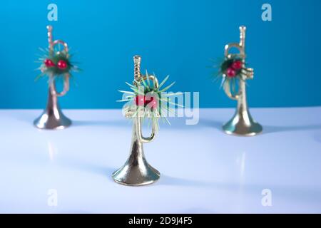 The trumpets festively decorated with a blue background. Christmas still life for musicians. Stock Photo