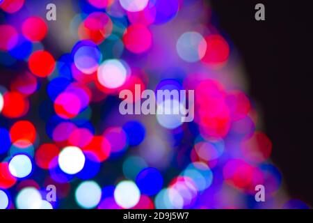 blurred red blue New Year lights on a black background, unfocused background Stock Photo