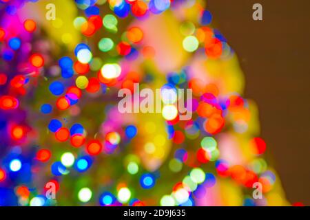 Blurred warm New Year's lights in the dark sky, unfocused background Stock Photo