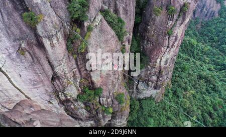 A slacking participant walks on a tight rope in the air at the 2020 Slacking Tournament in  Shenxianju Scenic Area in Taizhou city, east China's Zheji Stock Photo