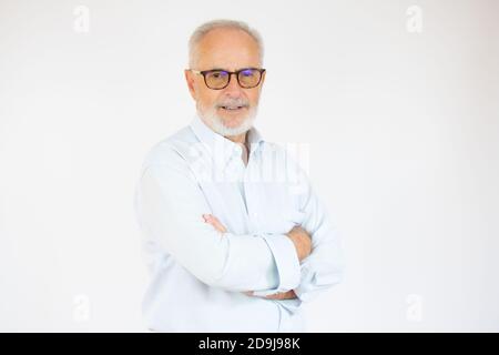 Portrait of cheerful senior man who is looking at camera and smiling over white background. Stock Photo