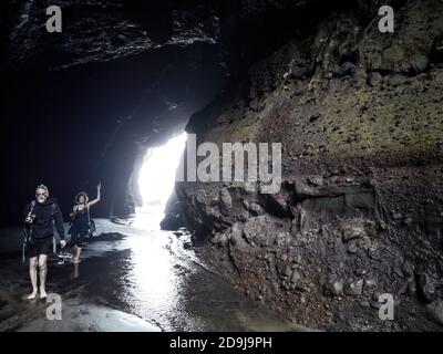 AUCKLAND, NEW ZEALAND - Nov 24, 2019: Auckland / New Zealand - November 24 2019: View of Piha Blowhole cave with photographers Stock Photo