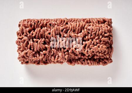 Black of raw plant based minced vegan meat substitute on a white background in an overhead view Stock Photo