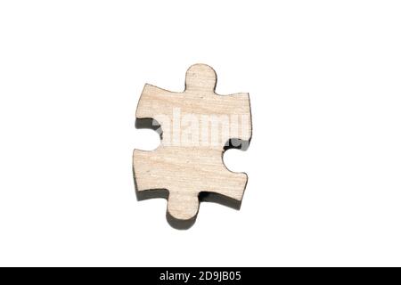 One wooden jigsaw puzzle piece isolated on white background Stock Photo