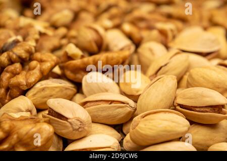 Pistachios and walnuts lie on the sacking. Close up Stock Photo