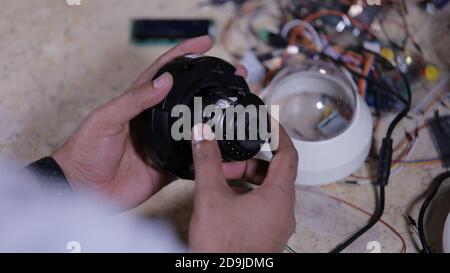 A man repairing CCTV camera in service centre Stock Photo