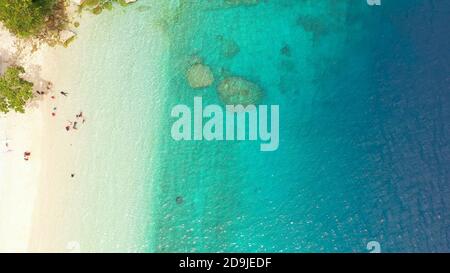 Tropical sandy beach with wave and turquoise water,copy space for text, aerial view. Sea water surface in lagoon. Transparent turquoise ocean water surface. Background texture Stock Photo