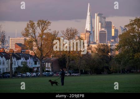The Shard on the distant Southbank and skyscrapers in the City of London's financial district are seen from Ruskin Park in south London, on 4th November 2020, in London, England. Stock Photo