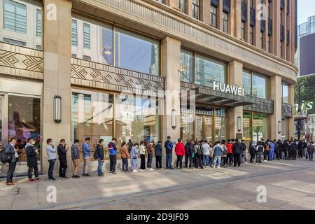 Customers queue at the flagship store of Huawei located on the east Nanjing road to book the newly released Huawei Mate 40 and experience products of Stock Photo