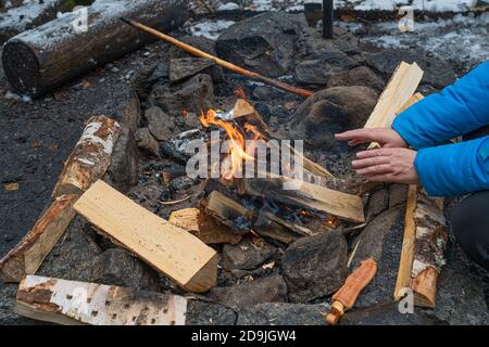 Women's hands by the fire. Cropped photo. High quality photo Stock Photo