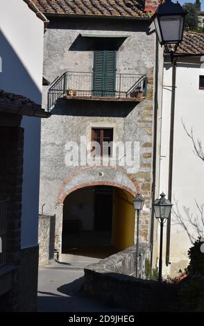 The contrast of light and shadow between the narrow street in Tuscany Italy Stock Photo