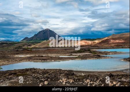Turquoise hot pools and a mighty volcano at Namafjall, Myvatn area - Iceland Stock Photo