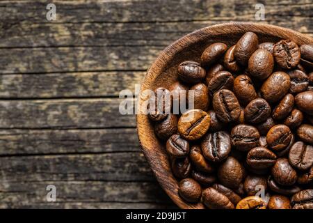 Roasted coffee beans on old wooden table. Top view. Stock Photo