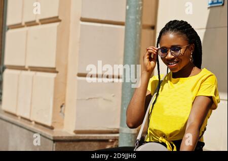 Portrait of  black African American woman in yellow t-shirt. Stock Photo