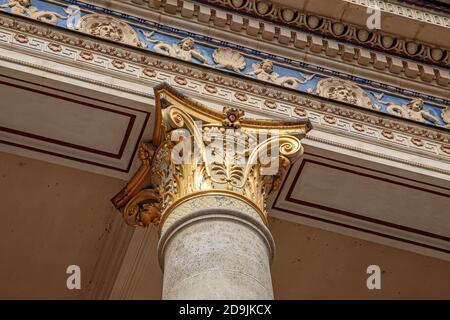 Top part of pillar, Greek-style columns with golden top Stock Photo