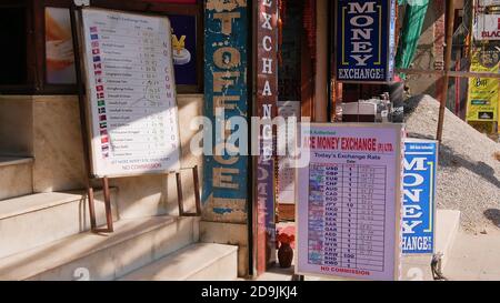 Kathmandu, Nepal - 11/11/2019: Signs displaying the daily exchange rate for Nepalese Rupees in different currencies in front of a exchange office. Stock Photo