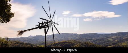 Styrian Tuscany like Vineyard with windmill, Panorama of grape crops in Slovenia spicnik. Stock Photo