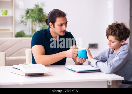 Father and disabled son in the education concept Stock Photo