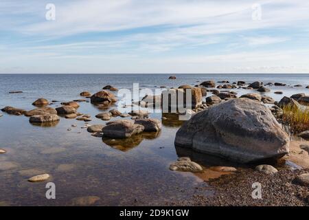 Granite stones on the beach of the Gulf of Finland in bright summer day Stock Photo