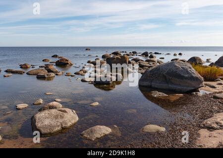 Granite stones on the beach of the Gulf of Finland in bright summer day Stock Photo