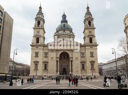Budapest, Hungary - March 27, 2018: Szent Istvan (St. Stephen) Bazilika in Budapest, Hungary. People walking in street in front of St Stephen Stock Photo