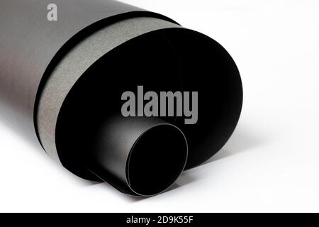 Abstract rolled textured black art papers isolated on white background Stock Photo